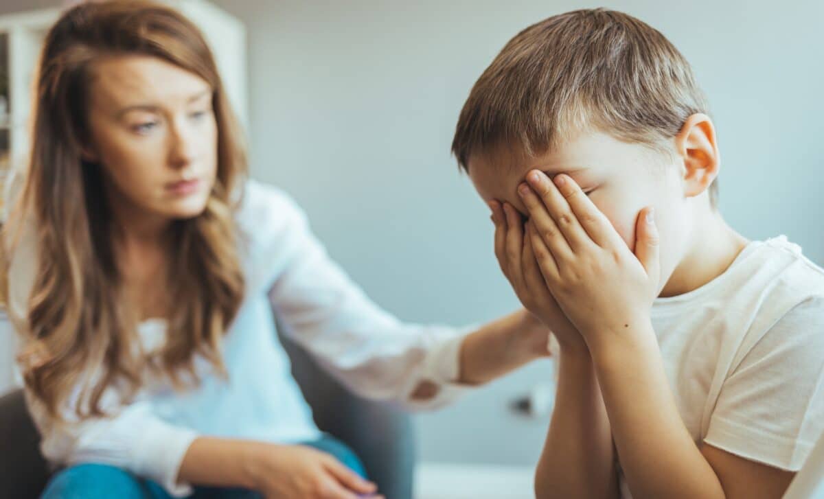 A distraught young boy crying