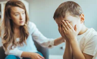 A distraught young boy crying
